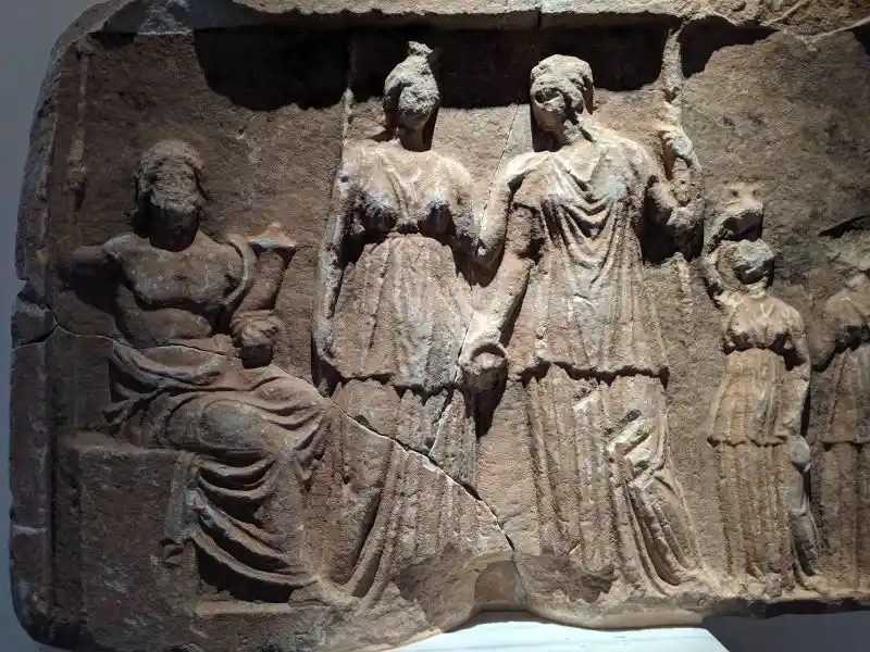 Stone carving of gods and worshippers
